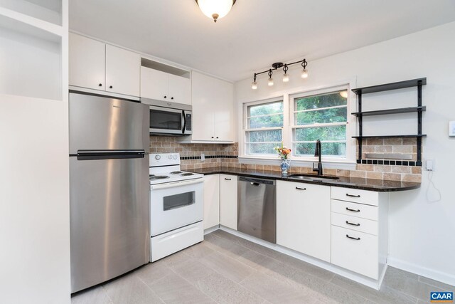 122 Westerly Ave, Charlottesville, VA 22903 - kitchen featuring appliances with stainless steel finishes, white cabinetry, decorative backsplash, open shelves, and light tile patterned floors