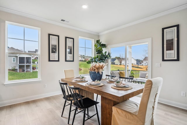 dining room featuring baseboards, ornamental molding, light wood-style floors, and recessed lighting