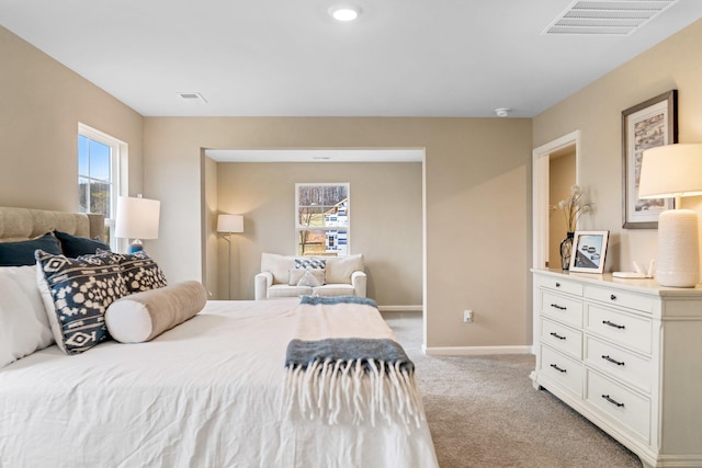 bedroom with light carpet and baseboards