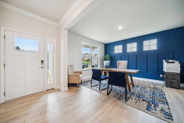 foyer featuring light wood finished floors, crown molding, baseboards, and recessed lighting