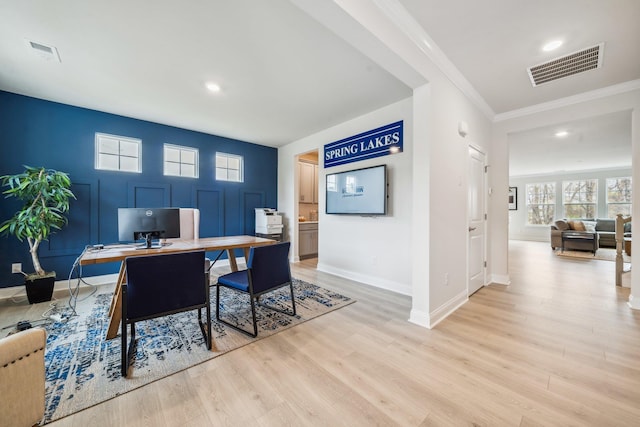 office featuring light wood-type flooring, baseboards, recessed lighting, and crown molding