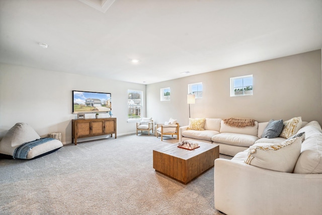 living area featuring light colored carpet and baseboards