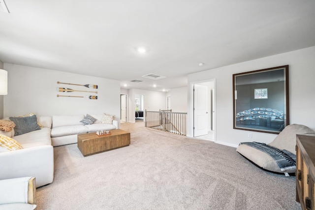 living room featuring carpet floors, attic access, recessed lighting, and baseboards