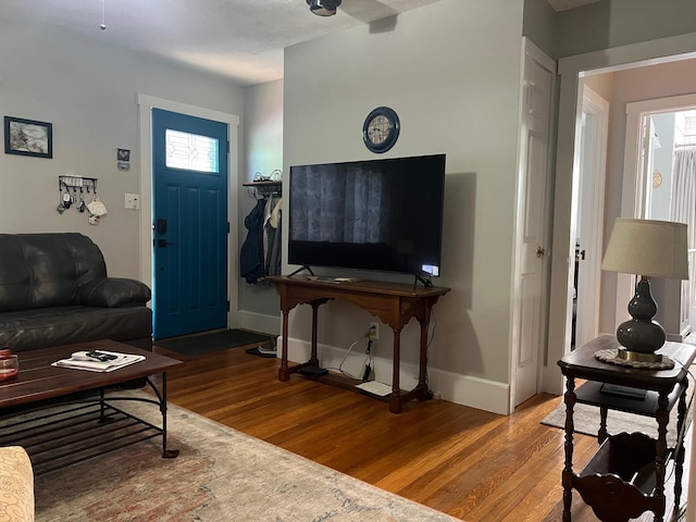 living room featuring wood finished floors and baseboards