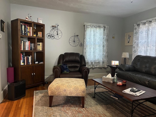 living area featuring wood finished floors and baseboards