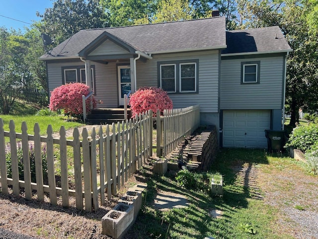 bungalow-style house featuring a garage, fence, and a shingled roof