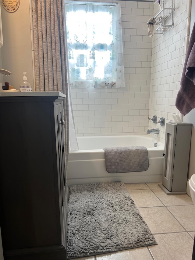 bathroom with tile patterned floors and shower / bath combo with shower curtain