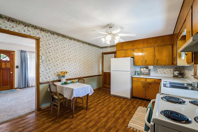 390 Frontier Dr, Staunton, VA 24401 - kitchen with white appliances, brown cabinetry, wallpapered walls, a sink, and dark wood finished floors