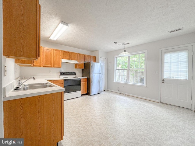 4110 Englandtown Rd, Fredericksburg, VA 22408 - kitchen featuring white electric range oven, a sink, freestanding refrigerator, under cabinet range hood, and light countertops