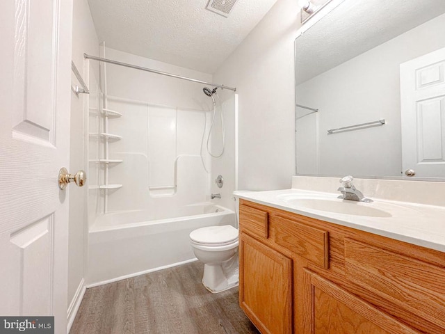 4110 Englandtown Rd, Fredericksburg, VA 22408 - bathroom featuring wood finished floors, toilet, a textured ceiling, vanity, and bathing tub / shower combination