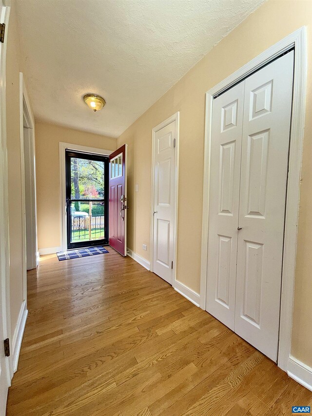405 Moseley Dr, Charlottesville, VA 22903 - foyer with light wood finished floors, baseboards, and a textured ceiling
