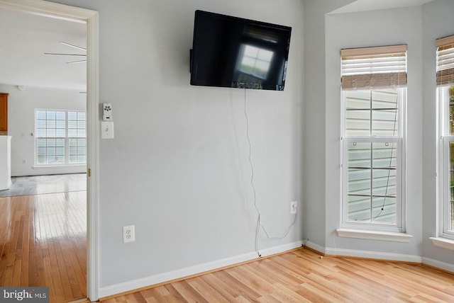 spare room with light wood-type flooring and baseboards