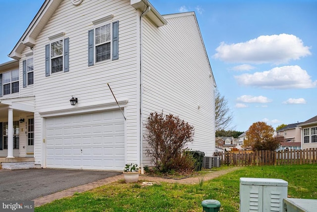 view of home's exterior with a garage and driveway