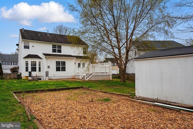 rear view of property with an outdoor structure, a wooden deck, and a shed