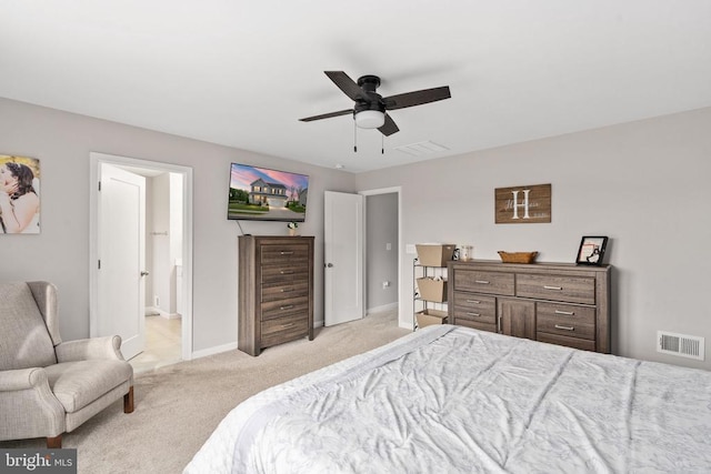 bedroom with light carpet, baseboards, ceiling fan, and connected bathroom