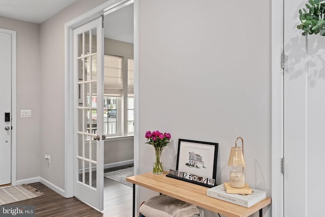 doorway featuring wood finished floors and baseboards