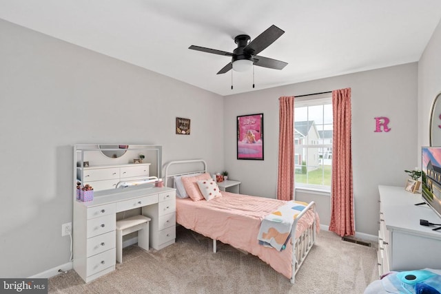 bedroom featuring light carpet, baseboards, and a ceiling fan
