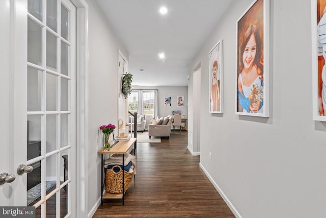 hall with dark wood finished floors, recessed lighting, baseboards, and french doors
