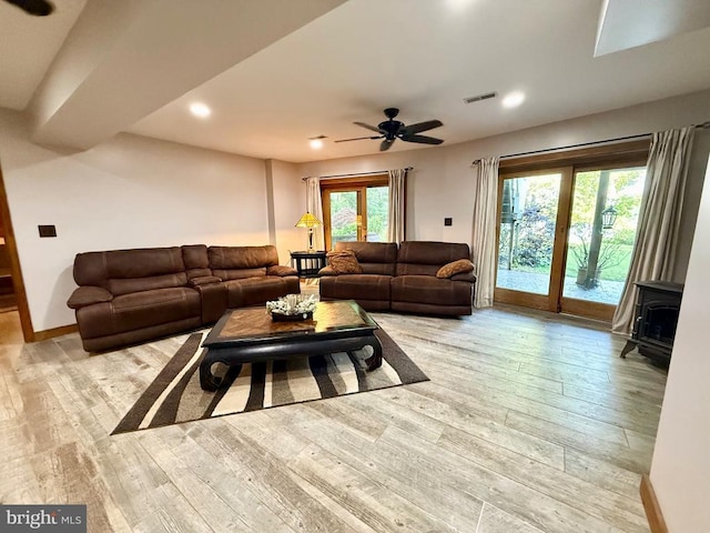 778 Overton Dr, Mineral, VA 23117 - living area with a wood stove, light wood-style flooring, a ceiling fan, recessed lighting, and baseboards