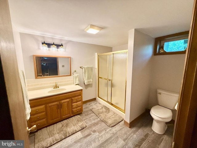 778 Overton Dr, Mineral, VA 23117 - full bathroom with wood finished floors, a stall shower, toilet, vanity, and baseboards