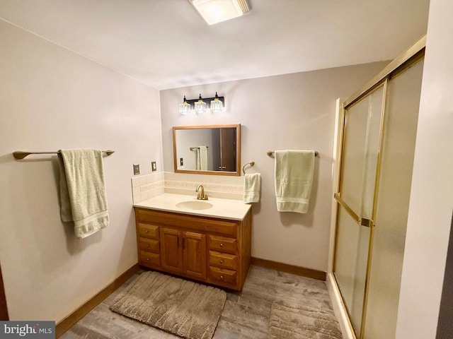 778 Overton Dr, Mineral, VA 23117 - bathroom featuring a shower stall, decorative backsplash, vanity, wood finished floors, and baseboards