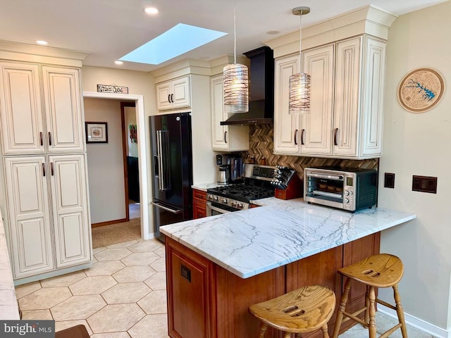778 Overton Dr, Mineral, VA 23117 - kitchen with stainless steel range with gas cooktop, wall chimney range hood, black refrigerator with ice dispenser, a skylight, and a peninsula