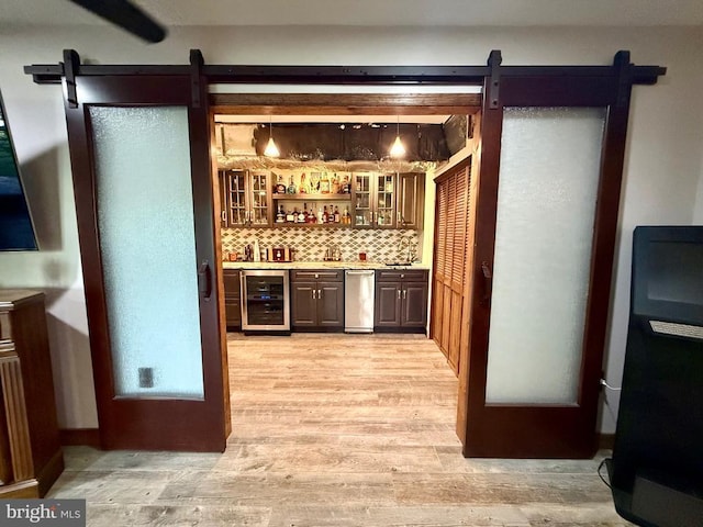 778 Overton Dr, Mineral, VA 23117 - indoor bar featuring a barn door, wine cooler, light wood-type flooring, and backsplash