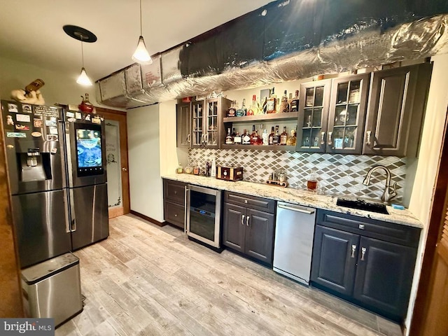 778 Overton Dr, Mineral, VA 23117 - indoor wet bar with beverage cooler, stainless steel appliances, backsplash, light wood-style flooring, and pendant lighting