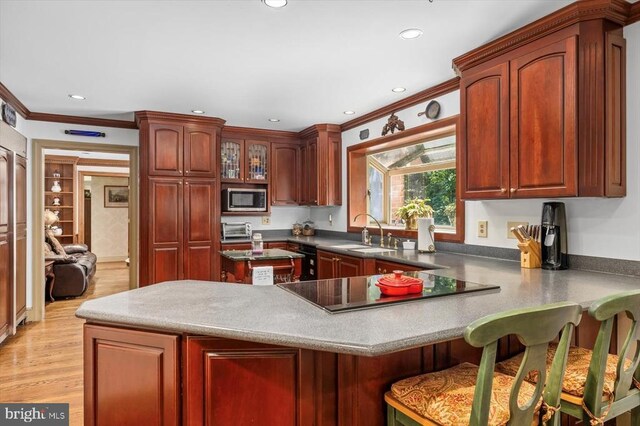 100 River Bend Rd W, Fredericksburg, VA 22407 - kitchen with stainless steel microwave, black electric cooktop, ornamental molding, a peninsula, and a kitchen breakfast bar