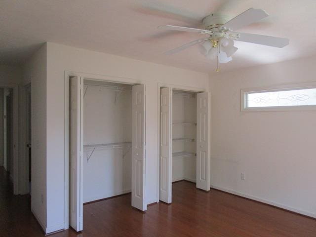 384 Hickory Grove Cir, Harrisonburg, VA 22801 - unfurnished bedroom featuring multiple closets, wood finished floors, ceiling fan, and baseboards