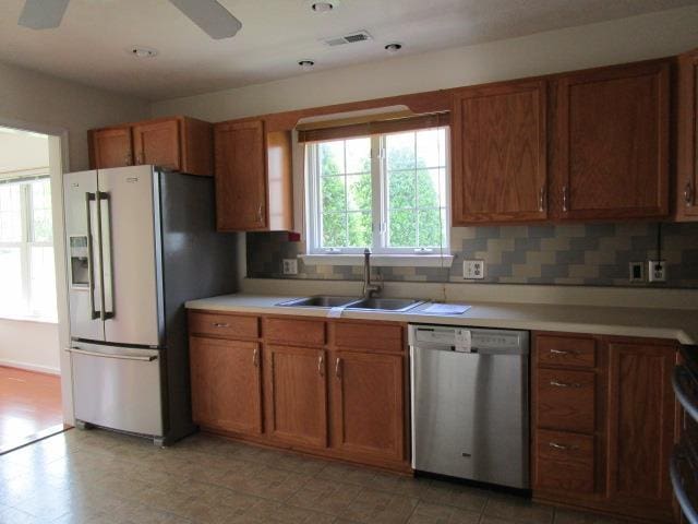 384 Hickory Grove Cir, Harrisonburg, VA 22801 - kitchen featuring appliances with stainless steel finishes, a sink, brown cabinetry, and tasteful backsplash