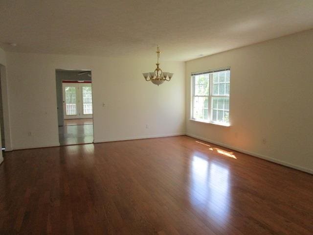 384 Hickory Grove Cir, Harrisonburg, VA 22801 - empty room with plenty of natural light, wood finished floors, a chandelier, and baseboards