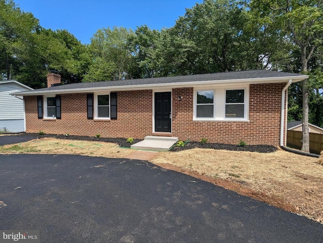 5 Timberland Dr, Fredericksburg, VA 22407 - ranch-style house featuring brick siding, a chimney, and view of scattered trees