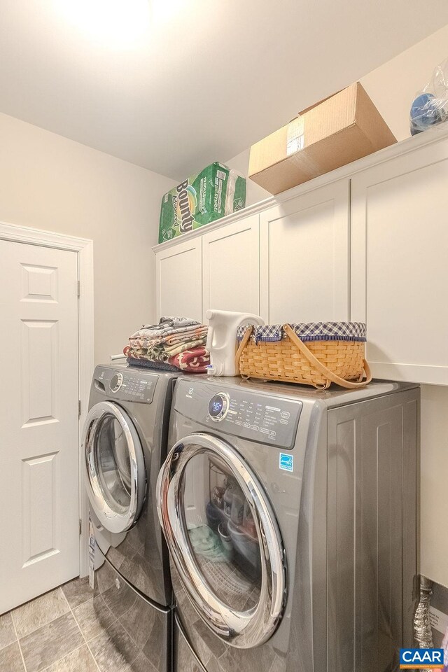 laundry area featuring washing machine and dryer and cabinet space
