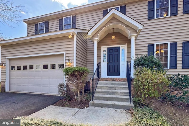 exterior space with driveway and an attached garage