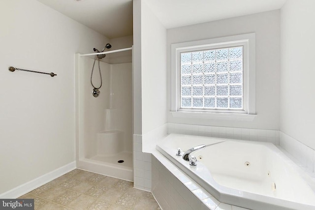 full bath featuring a jetted tub, baseboards, and a shower