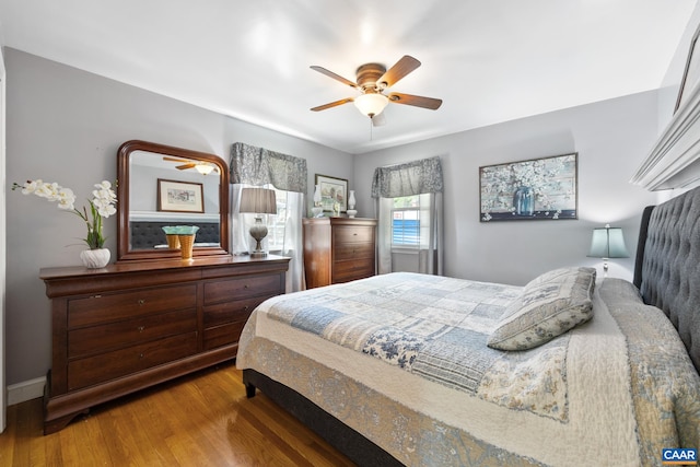 bedroom featuring wood finished floors, ceiling fan, and baseboards