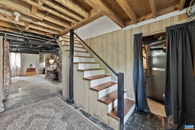 staircase featuring wooden walls