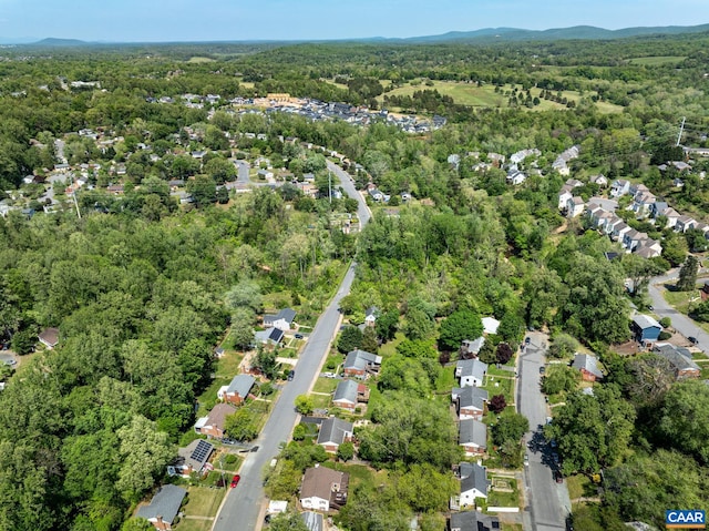 aerial view of property's location featuring a forest