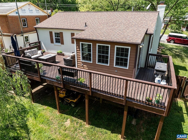rear view of house featuring an outdoor hangout area, roof with shingles, a wooden deck, a chimney, and a yard