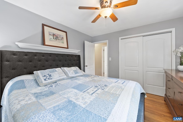bedroom featuring wood finished floors, a closet, and ceiling fan