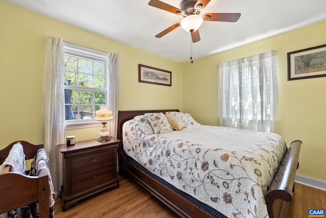 bedroom with wood finished floors and a ceiling fan