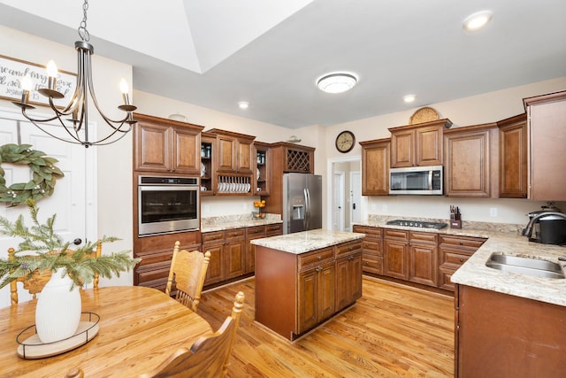 114 Jaspers Ln, Stuarts Draft, VA 24477 - kitchen with stainless steel appliances, a sink, brown cabinets, a chandelier, and light wood-style flooring