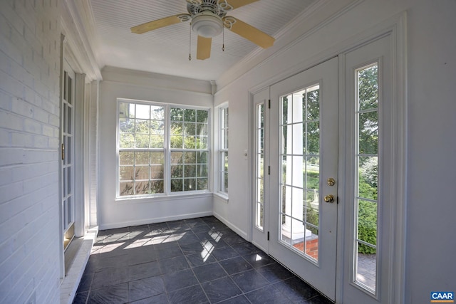 unfurnished sunroom with tile patterned floors, french doors, baseboards, and ornamental molding