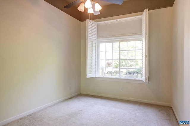 empty room featuring carpet, baseboards, and a ceiling fan