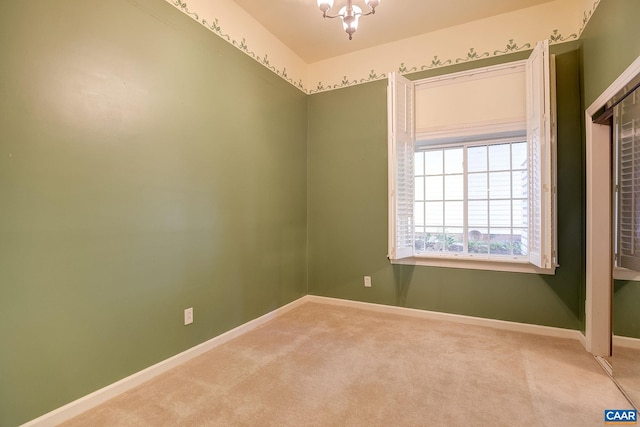 carpeted empty room with baseboards