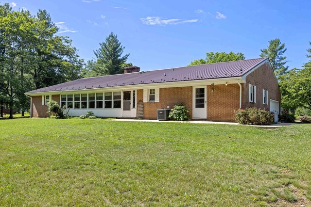 192 Sandy Ridge Rd, Waynesboro, VA 22801 - rear view of house featuring brick siding, a yard, a chimney, and a metal roof