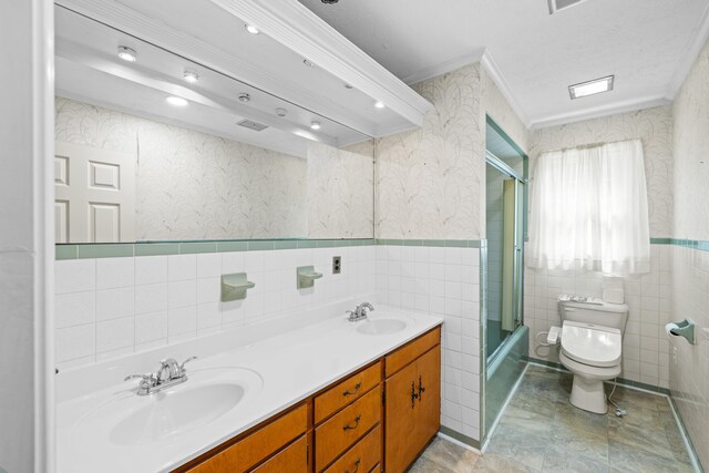 192 Sandy Ridge Rd, Waynesboro, VA 22801 - full bath with tile walls, double vanity, shower / bath combination with glass door, wallpapered walls, and crown molding