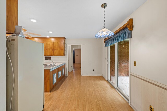 192 Sandy Ridge Rd, Waynesboro, VA 22801 - kitchen featuring refrigerator, light wood finished floors, brown cabinets, light countertops, and hanging light fixtures