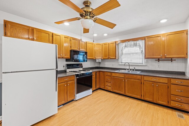 192 Sandy Ridge Rd, Waynesboro, VA 22801 - kitchen with white appliances, dark countertops, light wood finished floors, brown cabinets, and recessed lighting